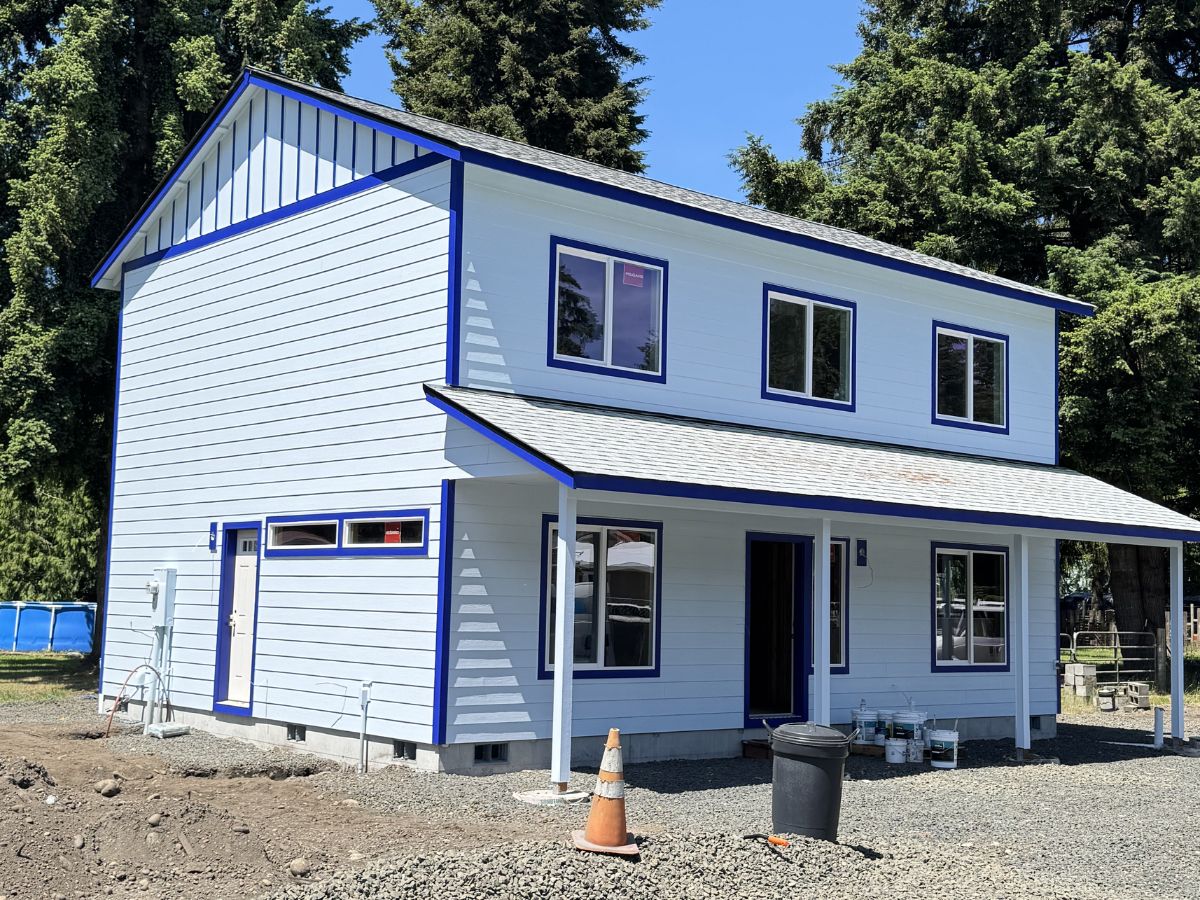 freshly painted two story home with modern white siding and crisp royal blue trim completed by Blissful Painting in Olympia, WA.